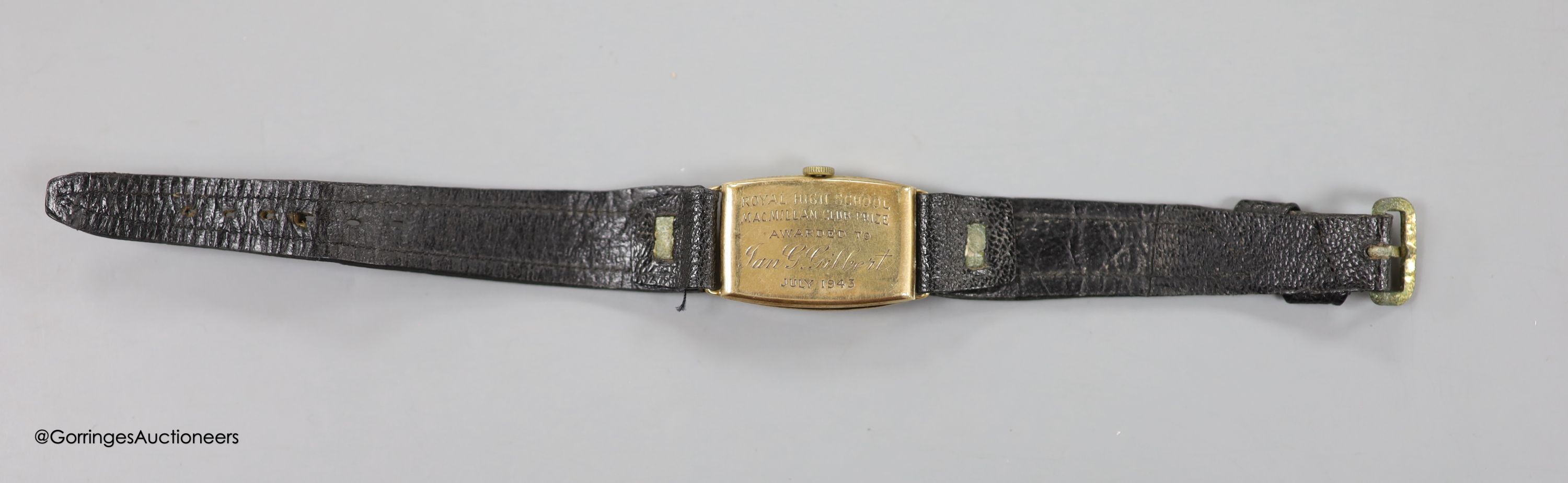 A gentleman's 1930's 9ct gold manual wind tonneau shaped wrist watch, with case back inscription, on leather strap